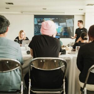 A diverse team in a modern office setting, collaborating during a meeting with a presentation.