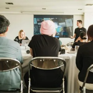 A diverse team in a modern office setting, collaborating during a meeting with a presentation.